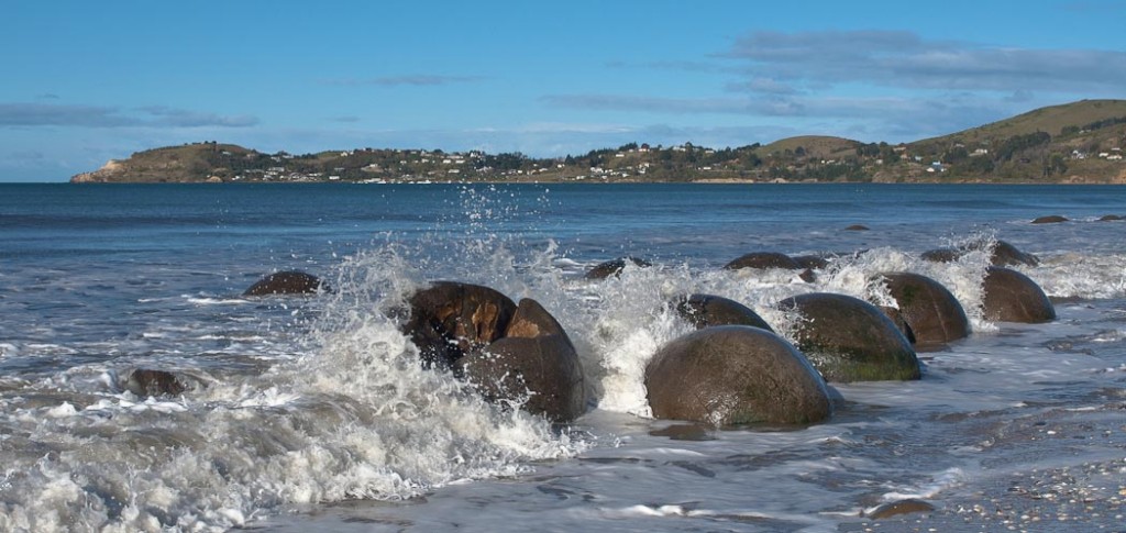 Some 60 million years ago, the concretions we know as the Moeraki boulders started forming on the ocean floor. Centuries of coastline erosion have revealed a spectacular view of these curiously large spherical boulders.   Local Māori legends explained the boulders as the remains of eel baskets, calabashes, and kumara washed ashore from the wreck of an Arai-te-uru, a large sailing canoe. This legend tells of the rocky shoals that extend seaward from Shag Point as being the petrified hull of this wreck and a nearby rocky promontory as being the body of the canoe's captain.