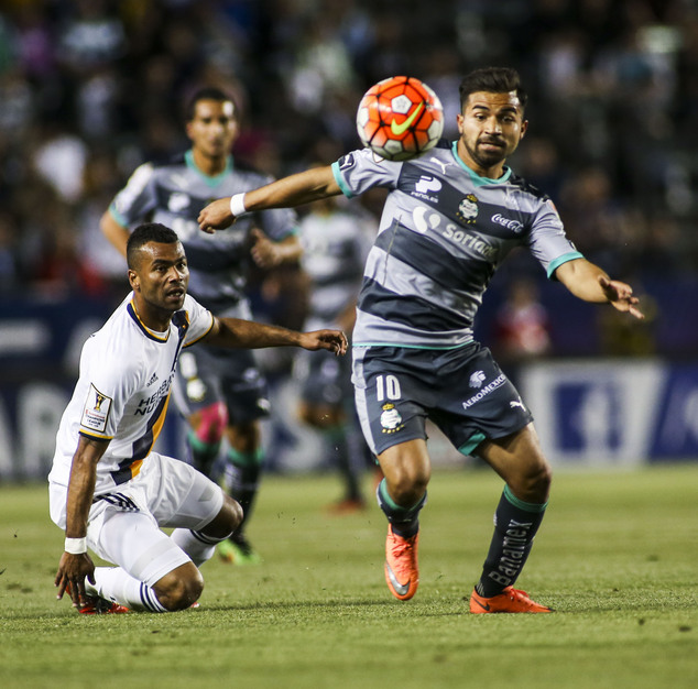 Santos Laguna midfielder Bryan Rabello, right, moves the ball away from Los Angeles Galaxy defender Ashley Cole during the first half of a CONCACAF Champions League soccer quarterfinal in Carson, Calif., Wednesday, Feb. 24, 2016. (AP Photo/Ringo H.W. Chiu)
